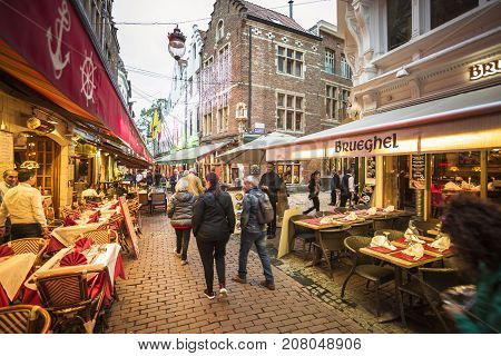 BRUSSELS BELGIUM - JUNE 18 2016: Picture of the Rue des Bouchers a street full of restaurants hotels and many people in a cloudy day. Brussels Belgium.