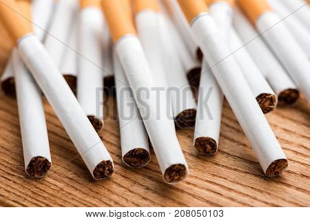 cigarette, cigarette on a wooden background, a pack of cigarettes, a close-up of a cigarette