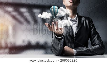 Closeup of business woman in suit presenting flying aerostate among clouds in her palm with office view on background. 3D rendering.
