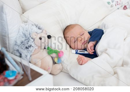Cute Newborn Baby Boy, Lying In Bed With Cold