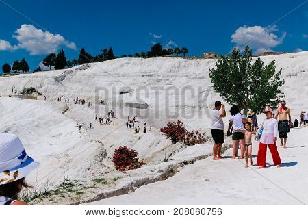 People In Travertine In Pamukkale Cotton Castle Which Is One Of The Unesco World Heritage Site In Tu