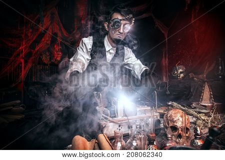 Scientist inventor steampunk works in his laboratory. Science fiction concept. Halloween.