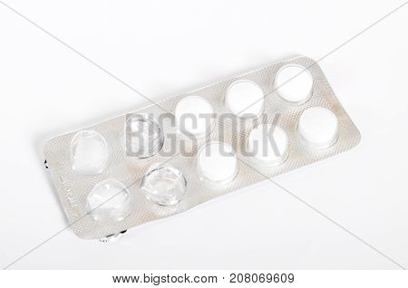 White packaged pills on a white background