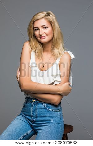 Beautiful Woman Posing In Fashion Style Sitting On Chair Gray Back Isolated.