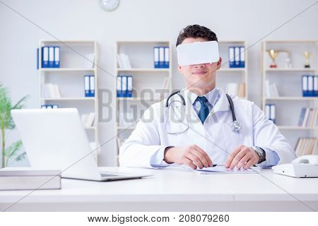 Young doctor with vr virtual reality headset working in the offi