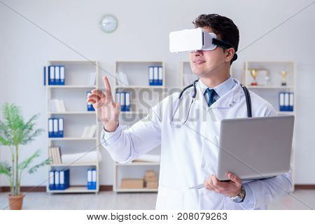 Young doctor with vr virtual reality headset working in the offi