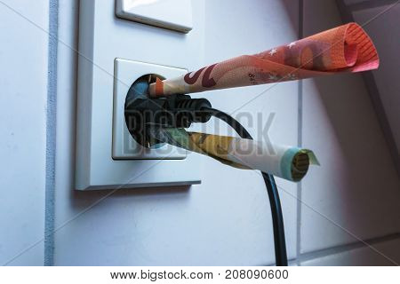 energy savings concept with power socket and money