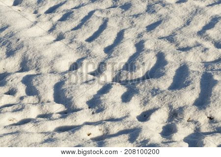 traces of transport on a plowed agricultural field, the photo is taken close-up from above