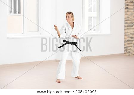 Female karate instructor training in dojo