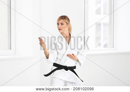 Female karate instructor training in dojo