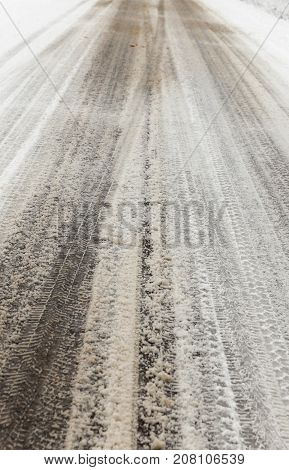 Traces Of The Tread On The Snow. Snow Covered In The Winter Season Of The Road. Photo Taken Close Up