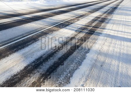 A Snow-covered Road In The Winter Season. Close-up Photo