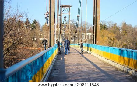Zhytomyr Ukraine - September 05 2015: Old woman call-down guys that climbing on wreck bridge at Zhytomyr Footbridge
