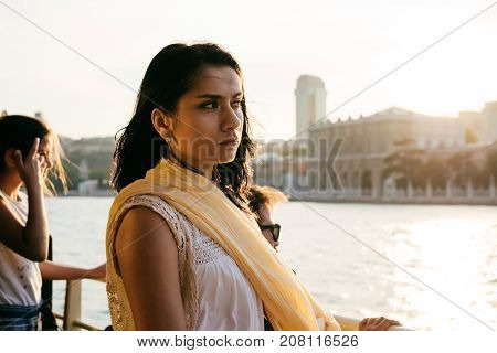 A girl looks at Istanbul at sunset during a tour of bosfor
