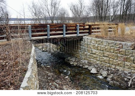 A bridge, along the Little Traverse Wheelway, which connects Charlevoix, Petoskey and Harbor Springs, Michigan, allows hikers and bicyclists to cross Tannery Creek.