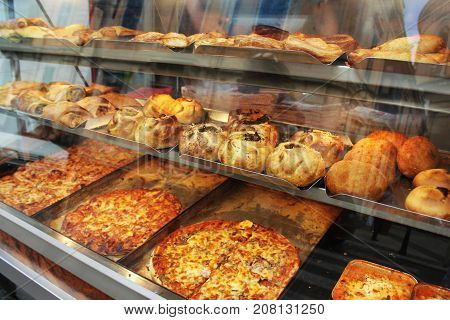 Traditional savoury pastry with filling. Fresh pastizzi and snacks for sale in a pastizzeria. Malta .