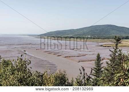 Low Tide Beach On Bay Of Fundy New Brunswick - Canada Brown Colored Water Called Chocolate River
