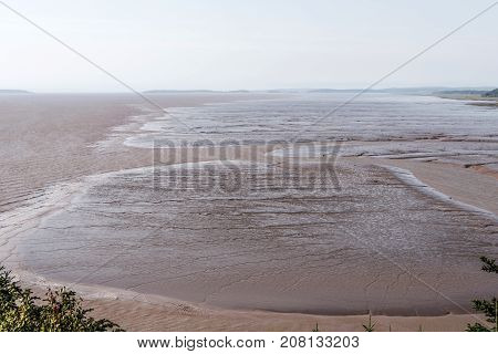 Low Tide Beach On Bay Of Fundy New Brunswick - Canada Brown Colored Water Called Chocolate River