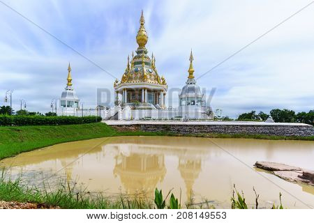 Magnificent Wat Thung Setthi (The Great Jewel Chedi of the three worlds) in beautiful day and reflection Khon Kaen Thailand
