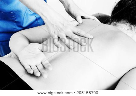 Physiotherapist, Chiropractor Giving A Massage And Stretching Of Subscapularis And Rhomboid To A Pat