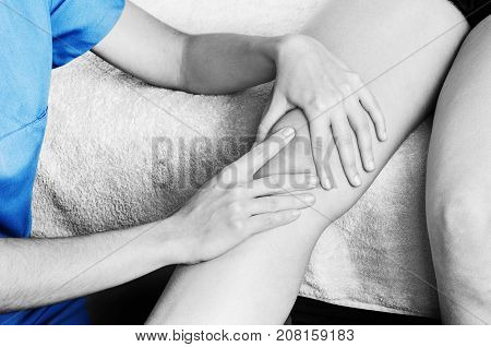 Physiotherapist, Chiropractor Doing A Patellar Mobilization, Knee Pain In Silhouette, Color And Blac