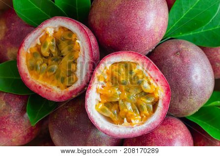 Fresh passion fruit on wood table in top view flat lay for background or wallpaper. Ripe passion fruit so delicious sweet and sour. Close up on half of passion fruit in macro concept. Tropical fruit. Passion fruit background macro concept.