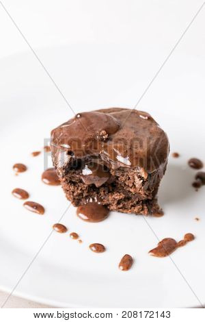 Sliced Chocolate Cup Cake Muffing With Topping Melting Chocolate Cream Above White Marble Background