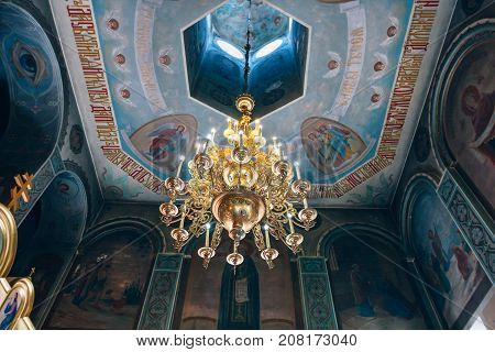 Dnipro Ukraine - August 06 2017: Church of St. Nicholas large gold or bronze chandelier in the temple or cathedral big bronze with handelier in the church orthodox church inside .
