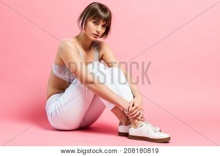 Young Woman Sitting On Floor