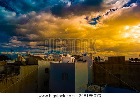 Hammamet, Tunisia. Image of architecture of old medina with dramatic sky at sunset time.