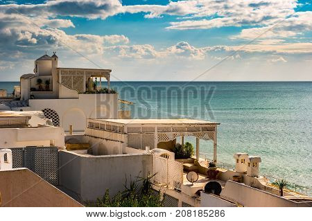 Hammamet, Tunisia. Image of architecture of old medina with dramatic sky at sunset time.