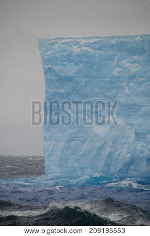 A large tabular iceberg floating in the southern atlantic ocean, near Antarctica.