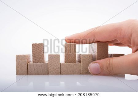 Hand Holding Wooden Domino