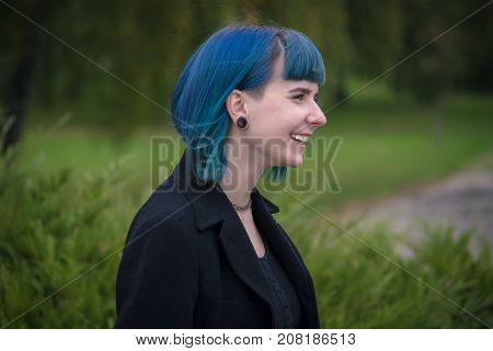Portrait Of Beautiful Smiling Blue Hair Schoolgirl In Profile