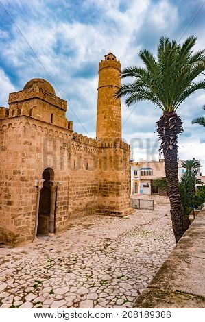 The walls and towers of the fortress of Ribat of Sousse in Tunisia. Medieval architecture in sunset light.