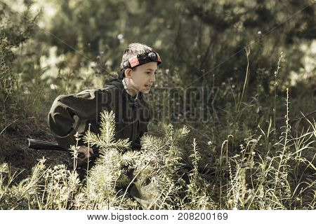 Child In Camouflage With A Gun Shoots, Laser Tag
