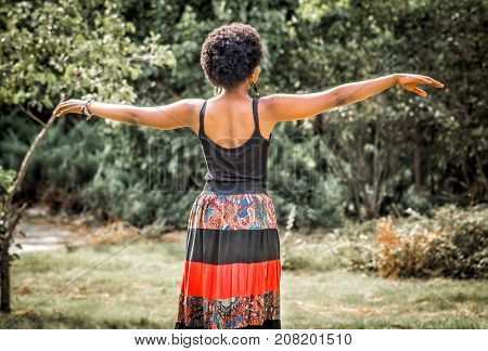 african girl is dancing traditional dance in the nature