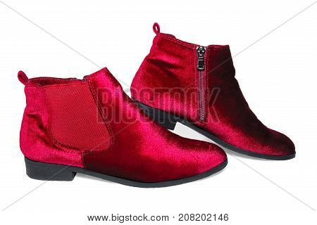 Lady's red velvet ankle boots isolated on white background.