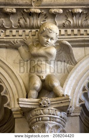 Stone sculpture of Angel on the wall of new chapel in Trogir Cathedral of saint Lawrence