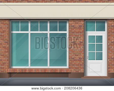 Store front with large transparent window. Facade of red brick. Empty glass showcase of boutique. Entrance in the small  shop.