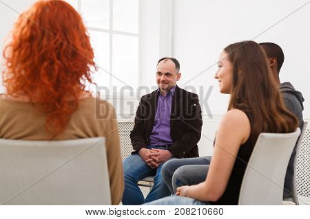 Meeting of support group. Man therapist listening to other people. Mental health, psychotherapy concept