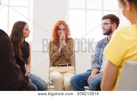 Meeting of support group. Young despaired woman crying during rehab group therapy. Psychotherapy, depression, life issues concept