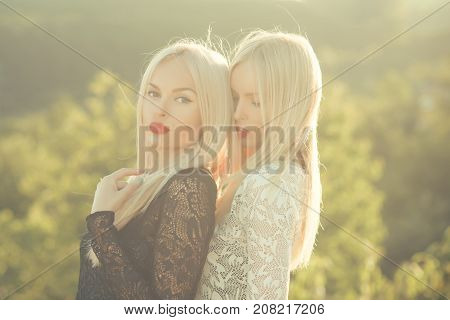 Sisters Twins Posing On Sunny Natural Landscape