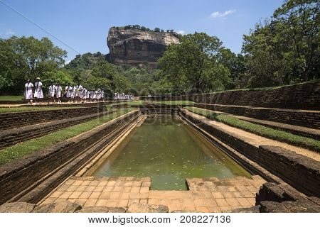 Sigiriya, Sri Lanka - March 23 2017: Students Of A School Class In White Uniforms On A Pathway At Li