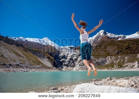 Woman Is Doing Yoga Excercises Near Big Lake On The Manaslu Circuit Trak In Nepala