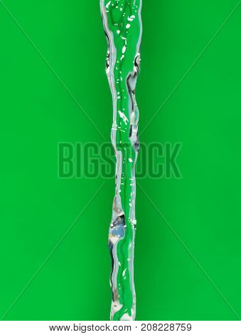 a jet of water on a green background