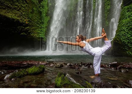 Woman Meditating Doing Yoga Between Waterfalls
