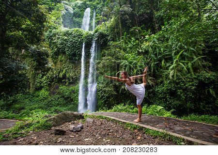 Woman Meditating Doing Yoga Between Waterfalls