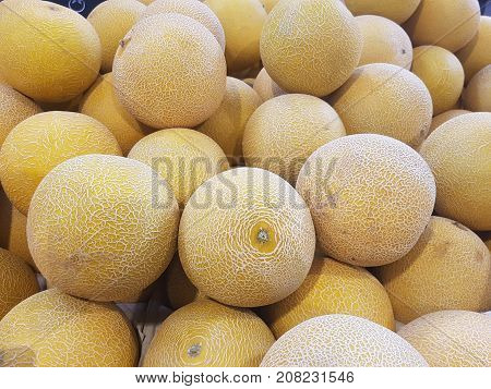 Honeydew melon in a pile at a shop