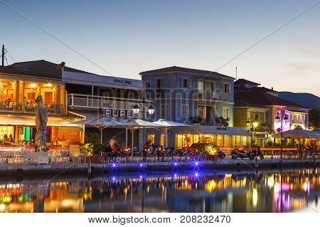 LEFKADA, GREECE - OCTOBER 1, 2017: Coffee shops and restaurants in the harbor of Lefkada town, Greece on October 1, 2017.